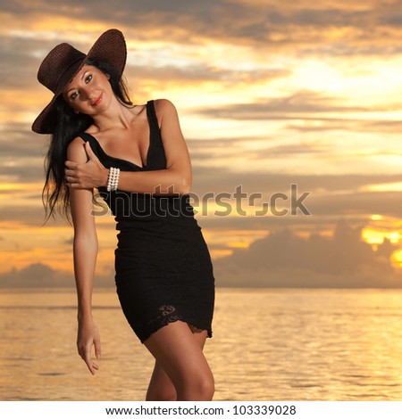 Fashion woman on the sea sunset background