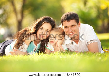 Happy mother father and daughter in the park Happy mother father and daughter in the park