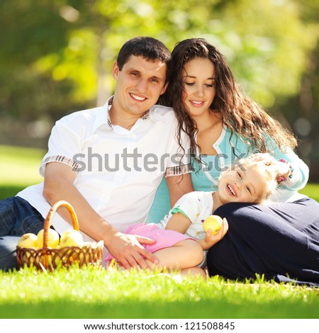 Happy family having a picnic in the green garden