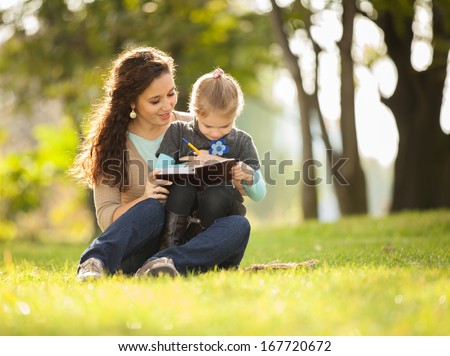 Mother with daughter playing in the park