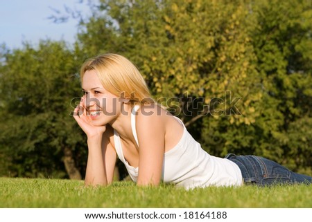 sweet woman rest on the green summer grass