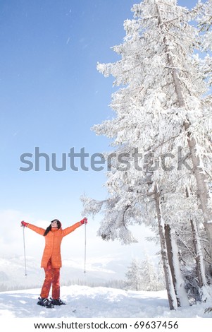 Happy girl with ski in the winter landscape