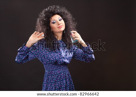 Young fashion woman with perfume on black background