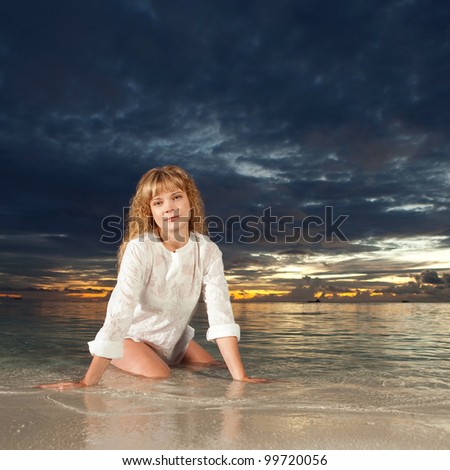 Cute woman on the sea sunset background