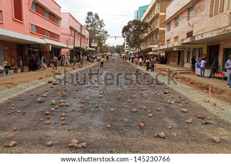 ARUSHA, TANZANIA - SEPTEMBER 10, 2012. A street is covered in rocks to stop cars from driving on it so the asphalt can cure in Arusha, Tanzania on September 10, 2012.