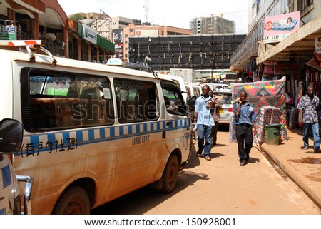 KAMPALA, UGANDA - SEPTEMBER 28, 2012.  Taxis line up on city streets while waiting to get into the main taxi station in Kampala, Uganda on September 28,2012.