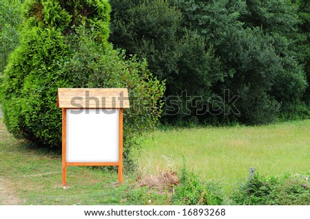 Empty wooden sign near a wood