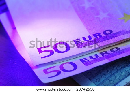 Fifty euros notes under real uv light