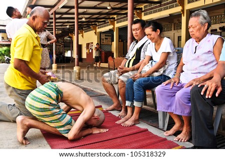 BANGKOK,THAILAND - MAY 26 : Naga (who will be ordained as the new one) pray and ask for forgiveness his family in the Newly Buddhist ordination ceremony on May 26, 2012 in the Temple,Bangkok,Thailand.