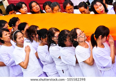 NAKHON PATHOM,THAILAND-JUNE 4: Clergy and Buddhist parade with yellow robe of Buddhist monk covering the golden pagoda in Visakha Bucha day to show respect and faith,4 June 2012 at Nakhon Pathom,Thai
