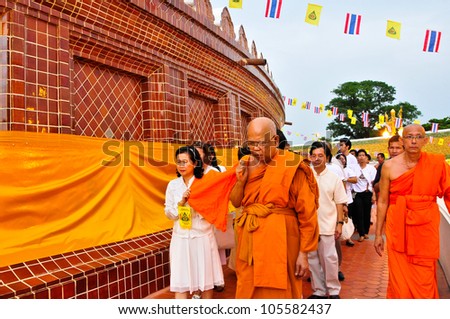 NAKHON PATHOM,THAILAND-JUNE 4: Clergy and Buddhist parade with yellow robe of Buddhist monk covering the golden pagoda in Visakha Bucha day to show respect and faith,4 June 2012 at Nakhon Pathom,Thai