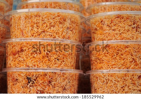 Sweet crispy noodles packed in plastic box.