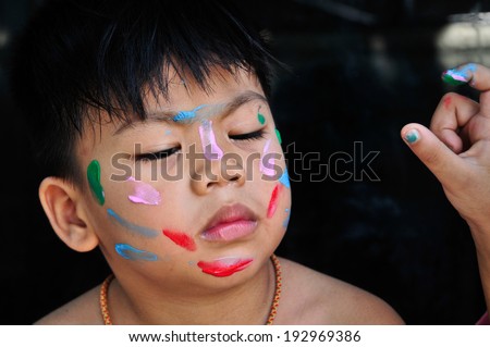 Asian boy play a game when he lose so was printing on face