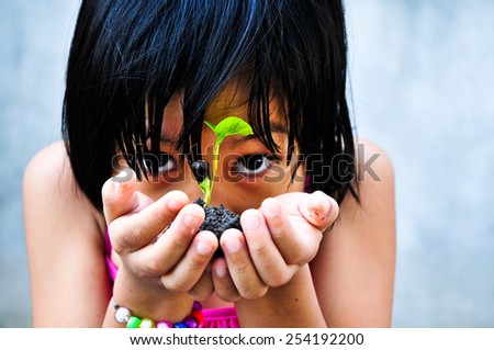 Asia girl were little planted in pots , Focus on little plant.