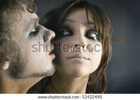man\'s and woman\'s face in pale makeup