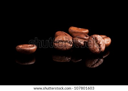 Luxurious aromatic coffee beans on black background. Luxurious coffee concept.