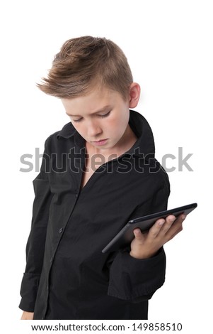 Cool boy in black dress shirt holding tablet isolated on white background.