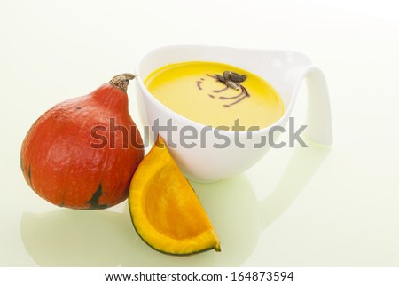 Seasonal autumn soup background. Hokkaido pumpkin and pumpkin soup isolated. Culinary soup eating.