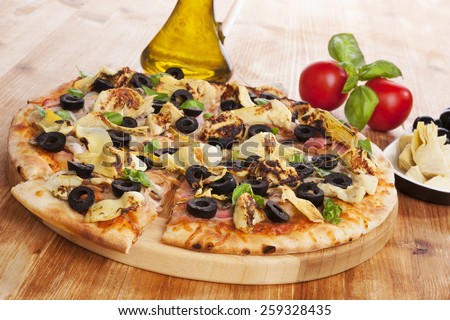Delicious pizza background. Fresh pizza, olive oil, on wooden background. Culinary pizza eating.