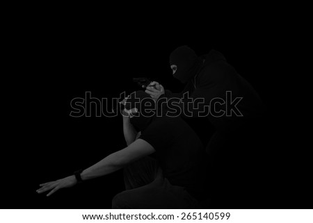Two masked man with gun and flashlight isolated on black background. Dangerous criminal committing crime.