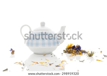 Delicious herbal tea mix with teapot isolated on white background. Healthy tea drinking.