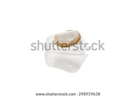 Euro money frozen in ice cubes isolated on white background. Frozen account, melting economy and transparent money flow.