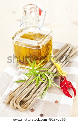 Traditional italian pasta with fresh herbs and olive oil on kitchen towel.