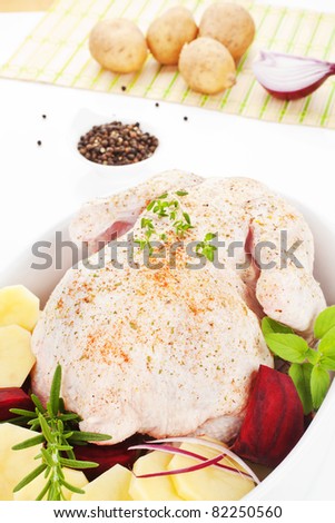 Delicious chicken with fresh herbs and vegetable in baking dish prepared for baking. Poultry.