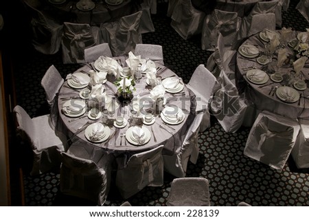  Spotlight on a round table at a hall decorated for a wedding reception