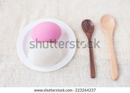 Salted egg and Preserved egg with wooden spoons on white fabric
