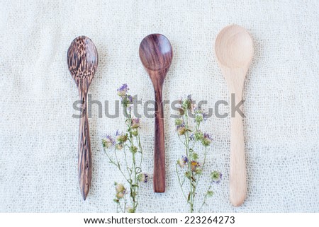Wooden spoons on white fabric background