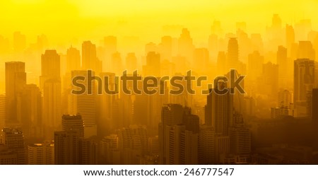 Sunrise over downtown Bangkok skyline, blurred