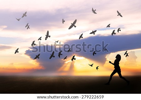 Girl feeling freedom on field during sunrise, birds flying around