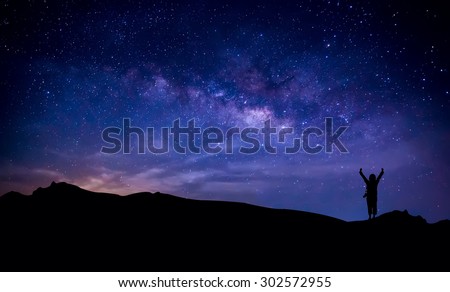 Silhouette of photographer at  mountain with milky way in the sky. Conceptual scene.