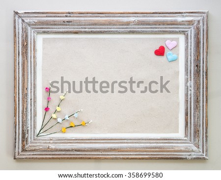 Vintage wooden frame with hearts and flower for Valentine's day background.