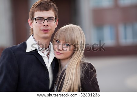 Man and woman staying together in the business style cloth