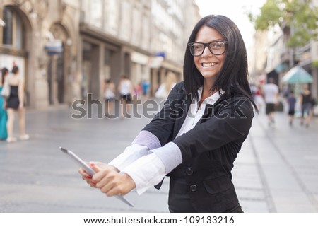 Smiling Business woman Using Tablet Computer on street, Business woman