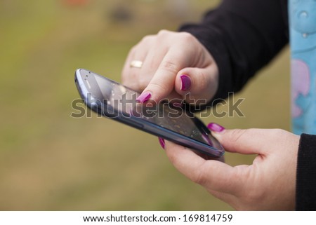 Man with smart phone on hand, blurred background