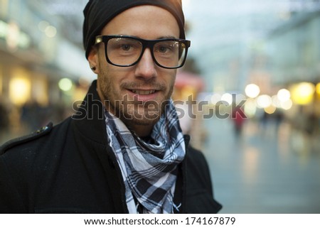 Portrait of fashion man on street, blurred city background
