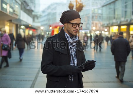 Young Man Searching Information Using An Tablet Computer.