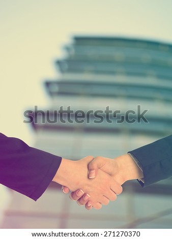 Handshake Handshaking and blured building in background