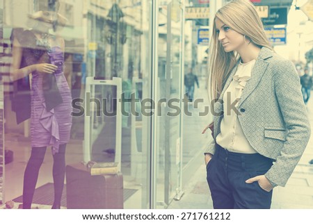 Customer woman in shoping street, looking at window, outdoor