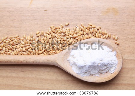 Wheat and flour isolated on wooden background