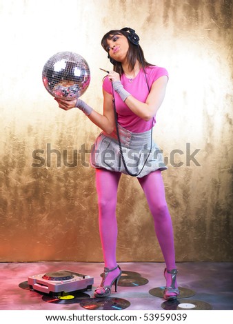 Disco Girls with Glitter Ball and Headphones In Night Club