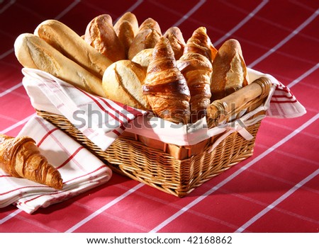 Baked goods in the basket on red tablecloth