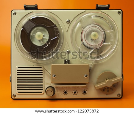 a small vintage reel to reel tape recorder