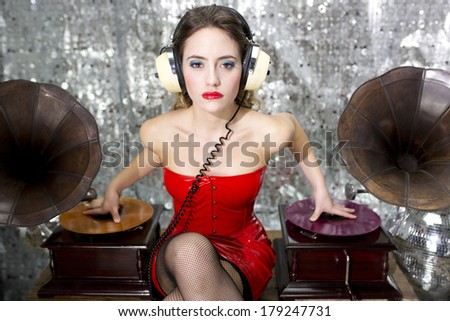 beautiful sexy disco dj in red dress with gramophones. Perfect for stylish club, disco and fashion events