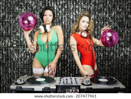 two beautiful sexy disco dj women in bikinis performing in a club setting. Useful for fashion, beauty, music and events