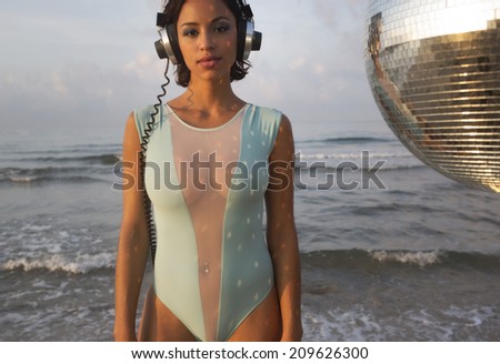 beautiful sexy latin bomb-shell dancing and posing at a beach in the early morning. useful for style fashion and music events
