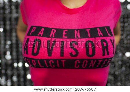 sexy woman dances in a tight t-shirt with the slogan parental advice explicit content.